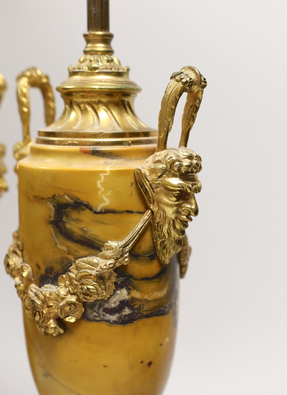 A pair of neo classical revival gilt metal and Siena marble lamps, 43cms high including light fitting